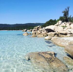 a large body of water with rocks and water at Isabella in Figari