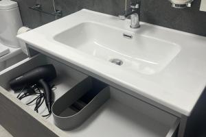 a bathroom with a white sink and a toilet at La Finestra sul Mare - Goelba in Chiessi +12 photos