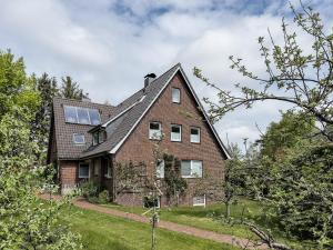 a brick house with solar panels on the roof at Haus *Üüs Aran* Wohnung Nr. 6 in Nebel