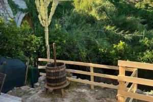 a wooden barrel sitting next to a wooden bench at La Finestra sul Mare - Goelba in Chiessi