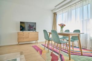 a dining room with a table and chairs at Central rooftop apartment with AC and city view in Basel