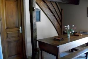 a room with a wooden table and a wooden door at Gîte de Pradevin in Jou-sous-Monjou