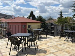 a group of tables and chairs on a patio at Relax Boutique House in Kranevo