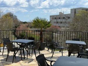 a patio with tables and chairs and a fence at Relax Boutique House in Kranevo