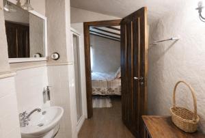 a bathroom with a sink and a toilet and a mirror at Casas de Xisto in Mogadouro +69 photos