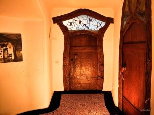 a wooden door in a room with a window at Ferienwohnung im Hoetger-Hof in Worpswede +6 photos