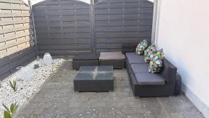 a patio with two couches and a table at Gemütliche 60m2 Wohnung mit Terasse in Künzing