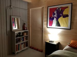 a bedroom with a bed and a book shelf with books at La chambre Kimono in Onnion +14 photos