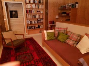 a living room with a couch and a chair at La chambre Kimono in Onnion