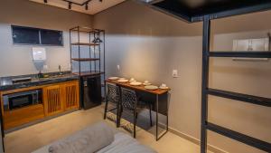 a living room with a bunk bed and a kitchen at Ap Passarela in Porto Seguro