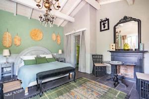 a bedroom with a bed and a mirror at Moulin de Lassalle in Linxe