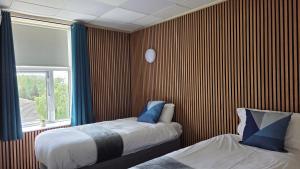 a bedroom with two beds and a window at The Devonshire House Hotel-Free Parking in Liverpool