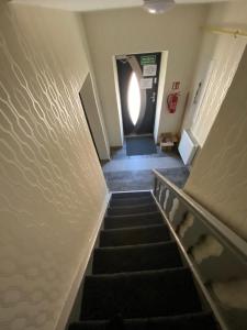 a flight of stairs in a building with a hallway at Noclegi in Starachowice