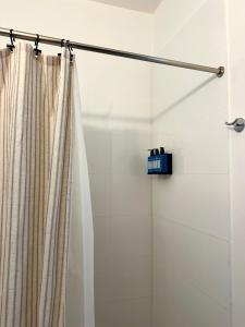 a shower with a shower curtain in a bathroom at La Estadia in San Juan +147 photos