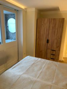 a bedroom with a bed and a wooden door at Kurzeit 38 in Bad Nenndorf