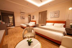 a hotel room with two beds and a table at Hotel California in Bangalore