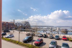 a group of cars parked in a parking lot near a marina at Hafenblick in Waren