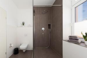 a shower with a glass door in a bathroom at Hafenblick in Waren +59 photos