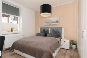 a bedroom with a bed and a black lamp at Hafenblick in Waren