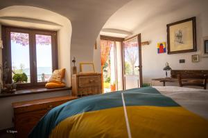 a bedroom with a bed and a window at Borgata Giostra in Caprie
