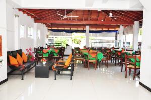 una sala da pranzo con tavoli e sedie in un ristorante di Hotel Blue Sky a Hikkaduwa