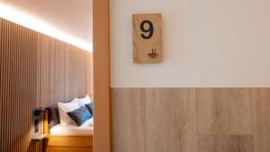 a room with a bed and a clock on the wall at Hueber der Wirt in Sankt Georgen an der Leys