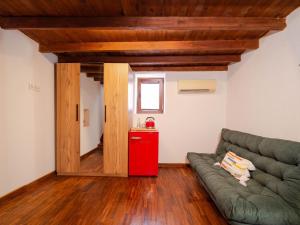 a living room with a couch and a red refrigerator at Muyo House in Urla