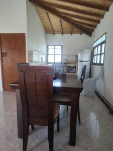 a kitchen with a wooden table in a room at Serena Grau in San Antero