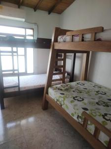 a bedroom with two bunk beds and a window at Serena Grau in San Antero