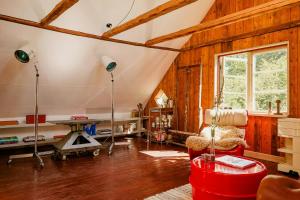 a living room with wooden walls and aamed ceilings at 1899 Loft In Creative Gylsboda in Lönsboda