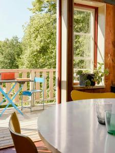 a table and chairs on a balcony with a window at 1899 Loft In Creative Gylsboda in Lönsboda