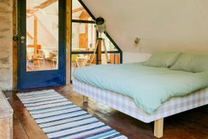 a bed sitting in a room with a window at 1899 Loft In Creative Gylsboda in Lönsboda