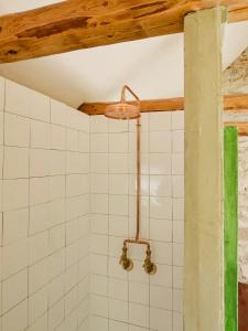 a bathroom with a shower with white tiles at 1899 Loft In Creative Gylsboda in Lönsboda +11 photos