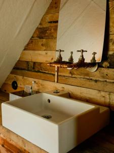 a bathroom with a white sink and a mirror at 1899 Loft In Creative Gylsboda in Lönsboda