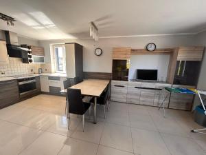 a kitchen with a table and chairs in a kitchen at Hostel Jagiellońska in Nowe Miasto Lubawskie