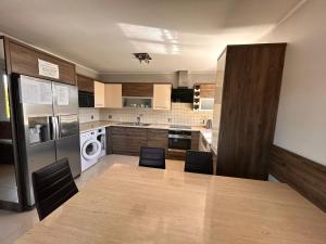 a kitchen with a table and two chairs in it at Hostel Jagiellońska in Nowe Miasto Lubawskie