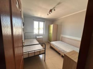 a small room with two beds and a window at Hostel Jagiellońska in Nowe Miasto Lubawskie