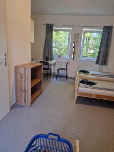 a bedroom with a bed and a desk and a table at Gruppenunterkunft für Firmen & Arbeiter in Laa an der Thaya in Laa an der Thaya +4 photos