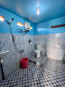 a bathroom with a toilet and a sink at Toraja Bungin Family House in Rantepao +90 photos