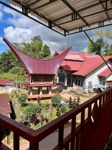 a view from a balcony of a building with a red roof at Toraja Bungin Family House in Rantepao