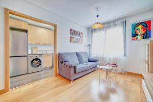 a living room with a couch and a table at Las Gaunas by Clabao in Logroño
