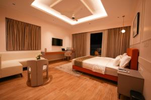 a hotel room with a bed and a desk at Hotel California in Bangalore +29 photos