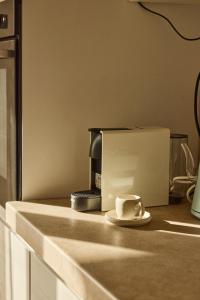 a microwave sitting on a counter with a piece of cake at Badesi Sea Dunes in Codaruina