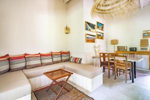 a living room with a couch and a table at Moulin de Lassalle in Linxe