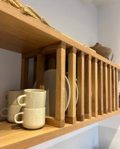 a wooden shelf with cups sitting on it at Kelya Houses in Kithnos