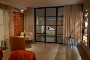 a living room with a large glass door at Hotel Spa El Muelle de Suances in Suances