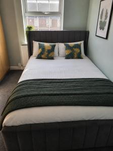 a large bed in a bedroom with a window at The Grimsby Heneage Stay in Grimsby