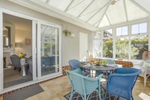 a dining room with blue chairs and a table at 2 Bed in Snape oc-12sf in Snape
