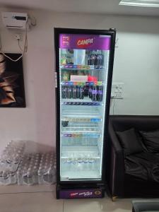 a refrigerator filled with bottles of soda at Vrind Orchid- Near Prem Mandir in Vrindāvan +47 photos
