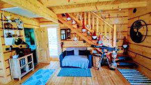 a bedroom with a staircase in a log cabin at Vila Vilinka & Vila Native Vilinija resort Village in Podčetrtek